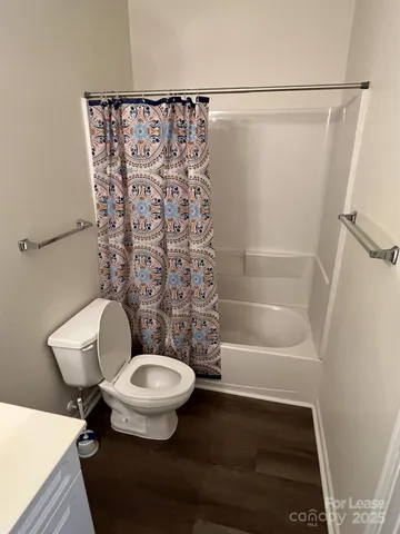 a bathroom with a toilet and a shower