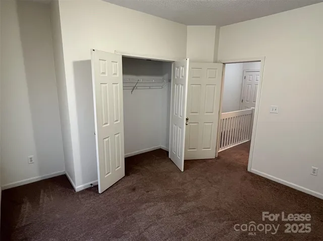 an empty room with closet area