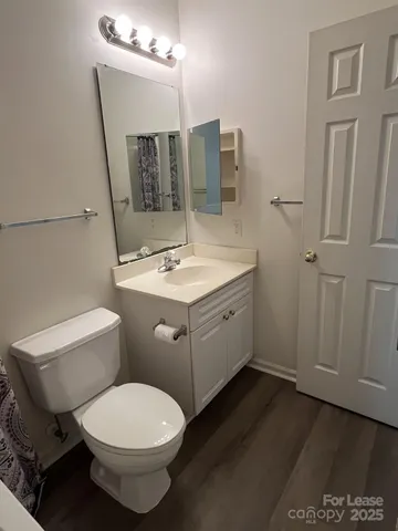 a bathroom with a toilet and a shower curtain