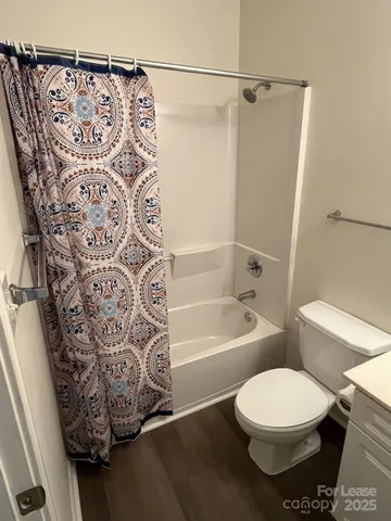 a view of a pathway of a building with wooden fence