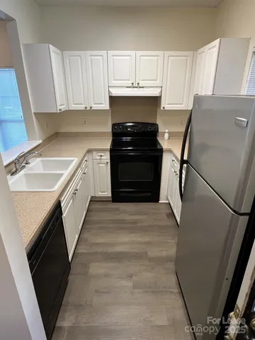 a kitchen with a sink stove and refrigerator