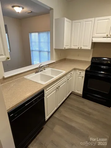 a kitchen with granite countertop a stove and a sink