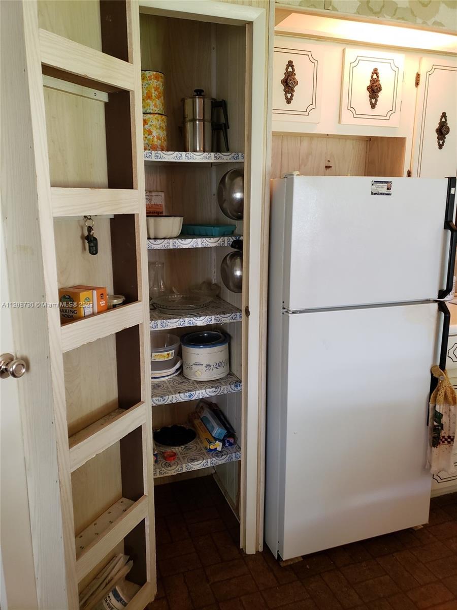 3502 Delaware Sebring, FL 33870 - Photo 12 of 21 a kitchen with a refrigerator and a refrigerator