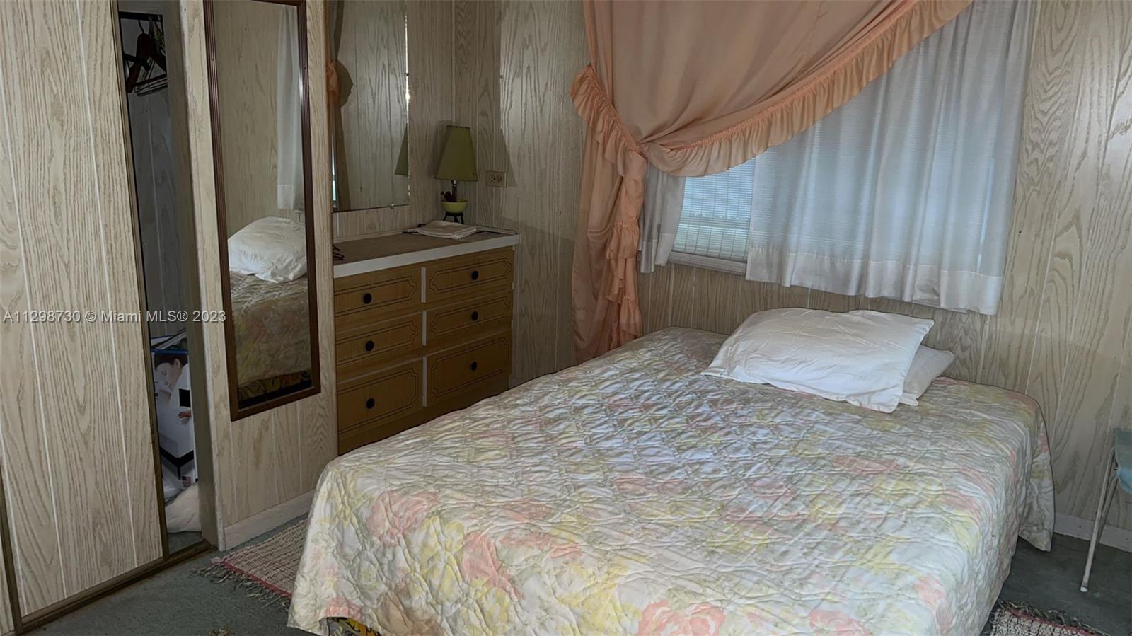 3502 Delaware Sebring, FL 33870 - Photo 15 of 21 a bedroom with a bed and a mirror