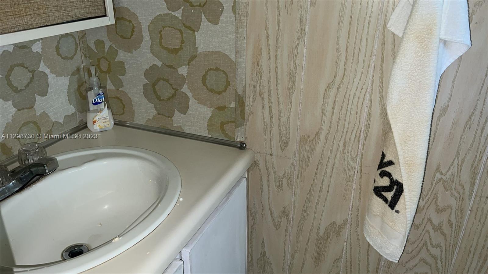 3502 Delaware Sebring, FL 33870 - Photo 17 of 21 a bathroom with a sink and mirror