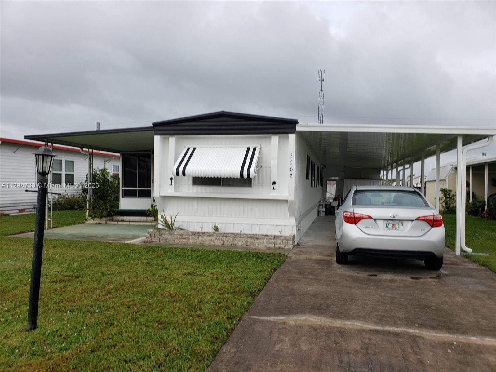 3502 Delaware Sebring, FL 33870 - Photo 20 of 21 a view of parking area and car parked