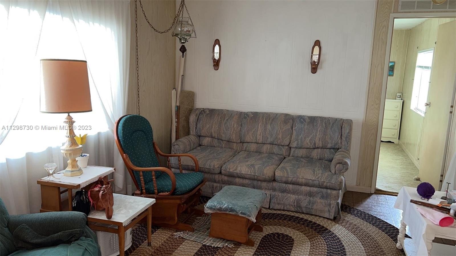 3502 Delaware Sebring, FL 33870 - Photo 3 of 21 a living room with furniture and a lamp