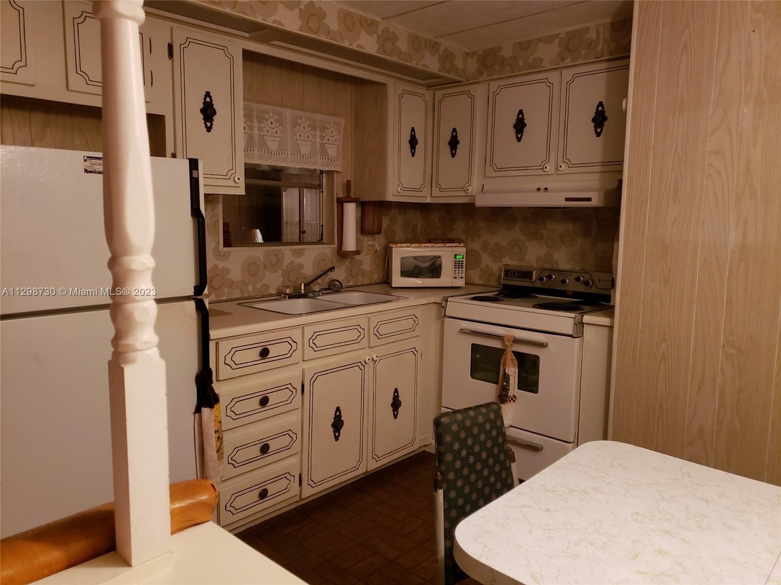 3502 Delaware Sebring, FL 33870 - Photo 10 of 21 a kitchen with stainless steel appliances a stove and a refrigerator