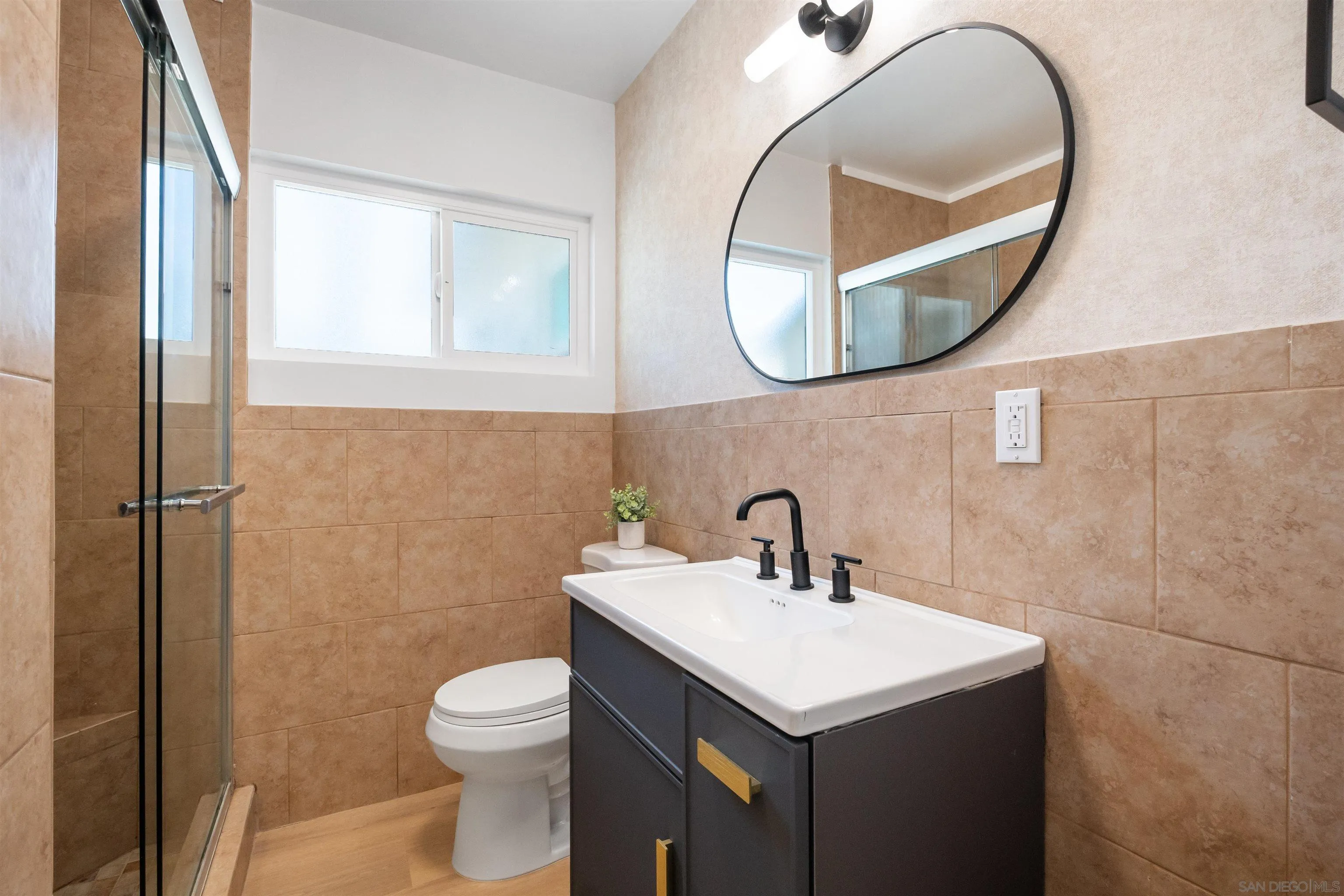 3465 Par Drive La Mesa, CA 91941 - Photo 14 of 16 a bathroom with a sink a mirror and a toilet