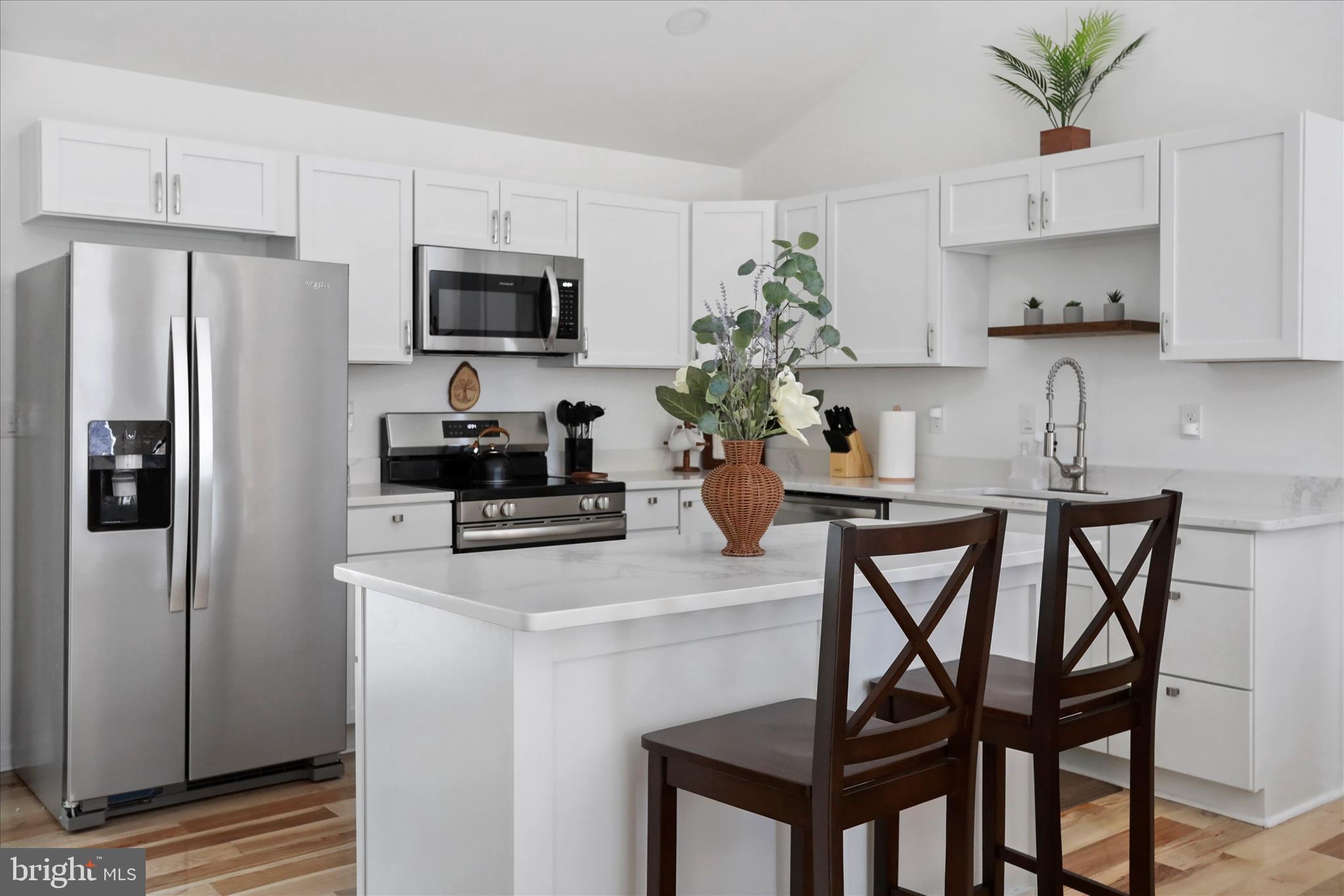 598 Crabapple Road Mount Jackson, VA 22842 - Photo 14 of 32 a kitchen with a table chairs refrigerator and microwave
