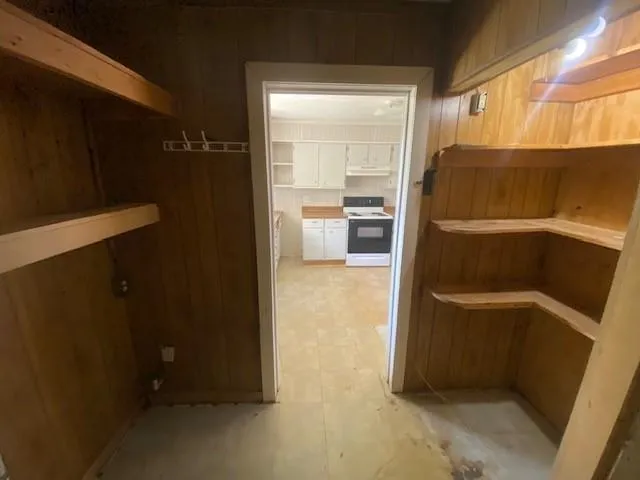 a view of a hallway with a chandelier fan