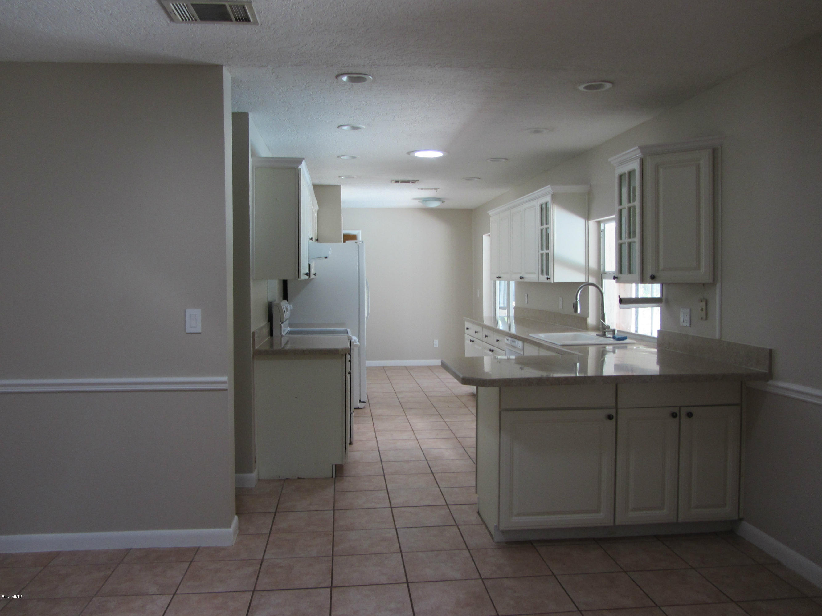 695 Caribbean Road Satellite Beach, FL 32937 - Photo 8 of 19 KItchen view from Family room