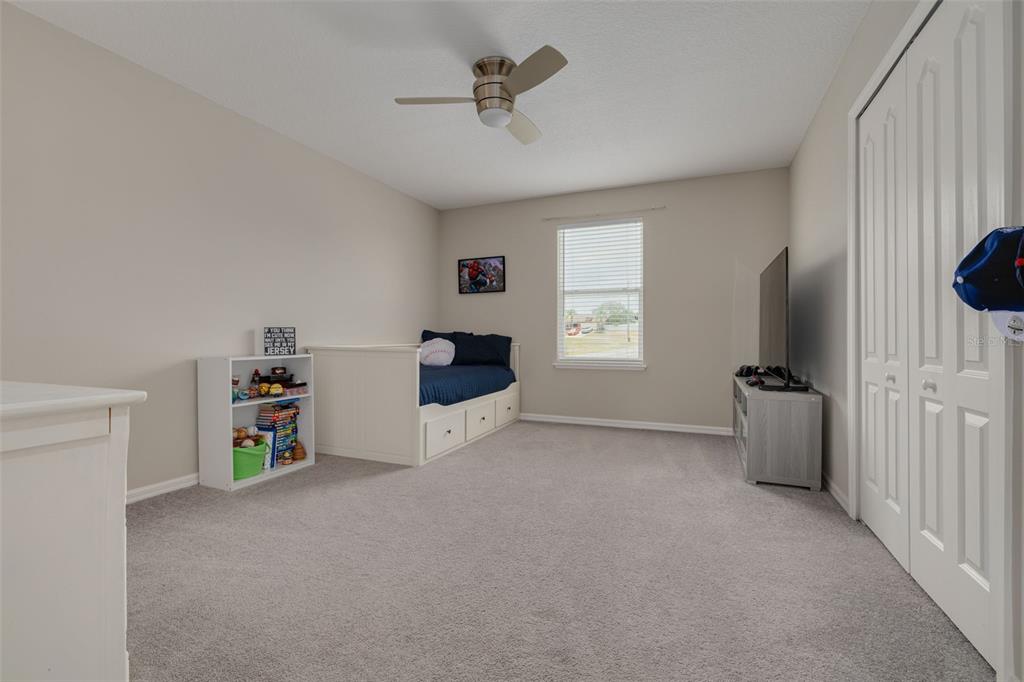 7242 Landmark Drive Spring Hill, FL 34606 - Photo 33 of 45 a room with a ceiling fan and a couch