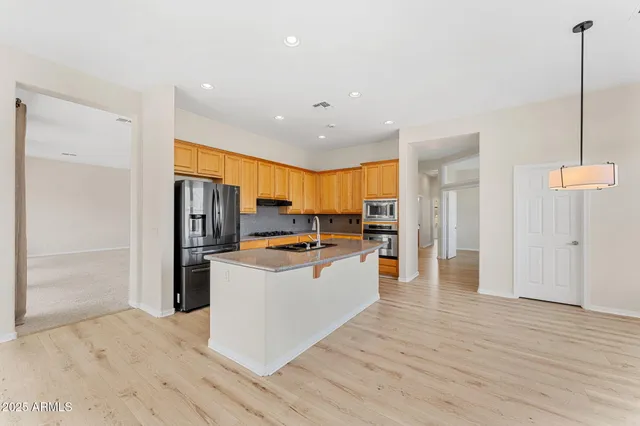 a kitchen with stainless steel appliances granite countertop a stove and a sink