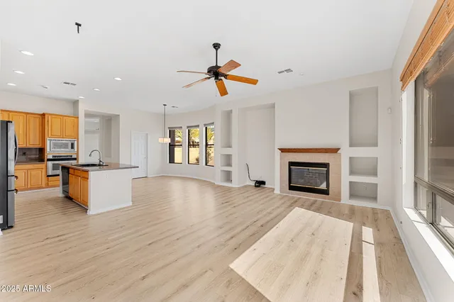 a view of empty room with fireplace and wooden floor