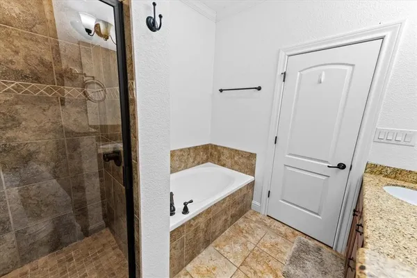 a bathroom with a tub and shower