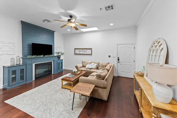 a living room with furniture a fireplace and a flat screen tv