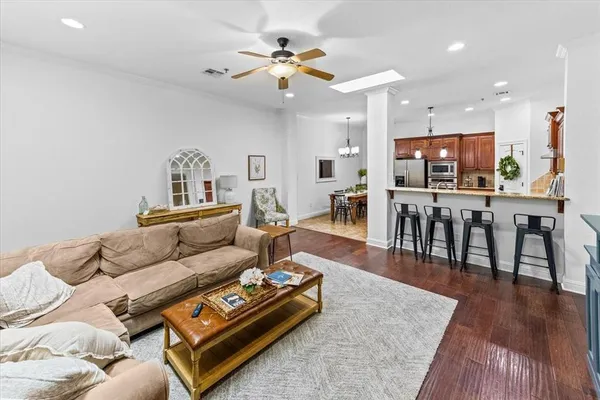 a living room with furniture and wooden floor