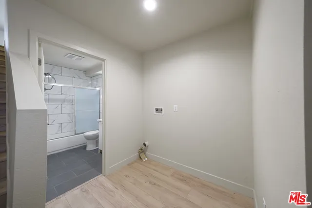 a bathroom with a granite countertop toilet and a shower