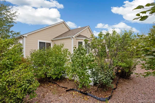a view of a house with a yard and garden