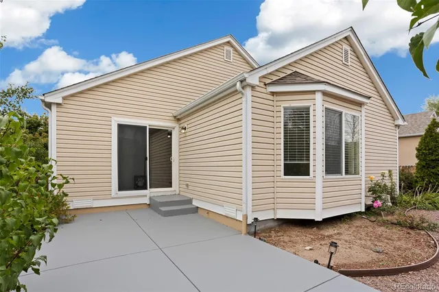 a view of a white house with a small space