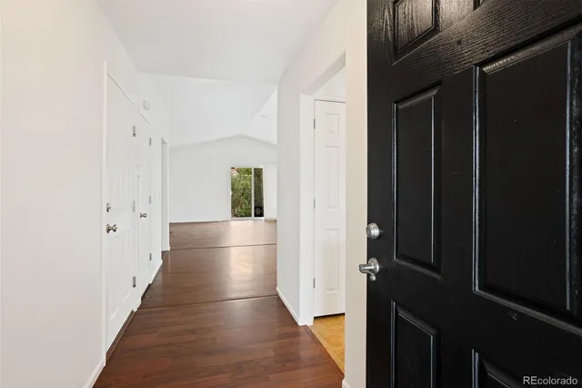 a view of hallway with wooden floor