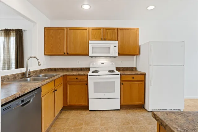 a kitchen with a sink stove and refrigerator