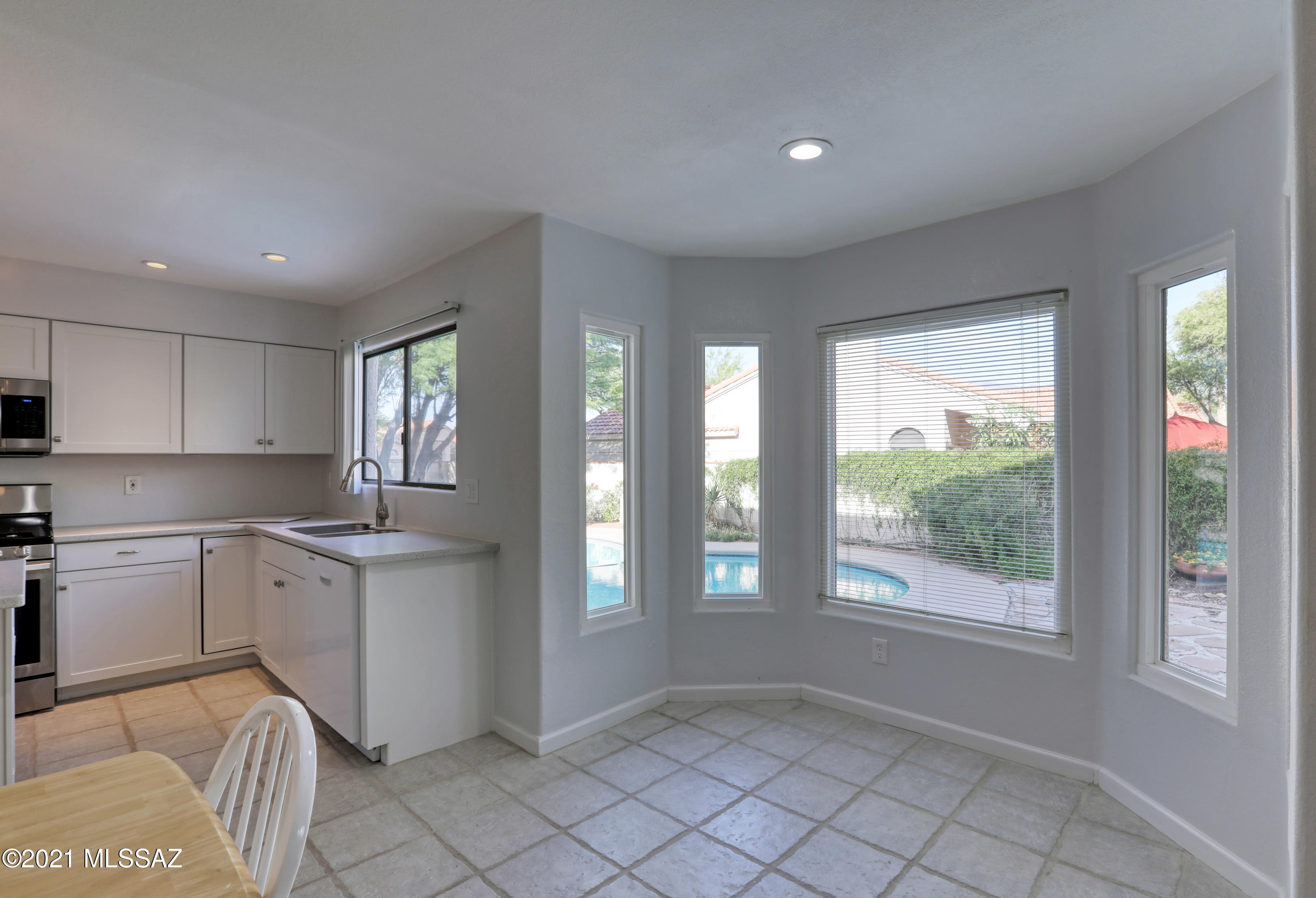 12560 North Wayfarer Way Oro Valley, AZ 85755 - Photo 12 of 43 a kitchen with stainless steel appliances granite countertop a stove a sink and a refrigerator