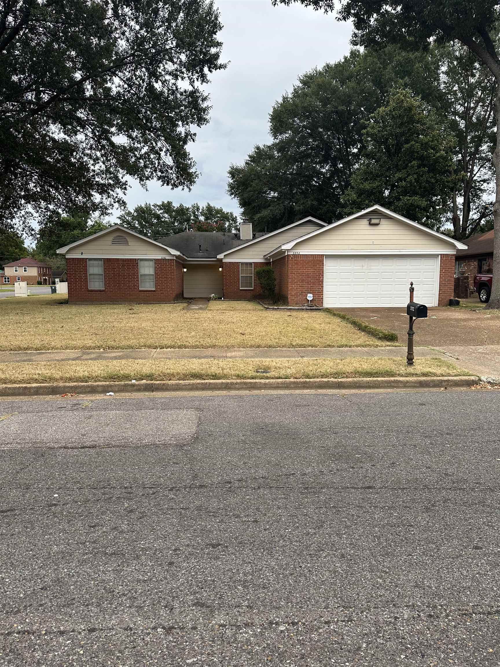3350 Adeline Street Memphis, TN 38118 - Photo 1 of 12 a front view of a house with a yard and garage