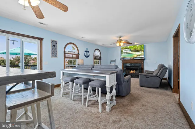 a living room with furniture a window and a flat screen tv