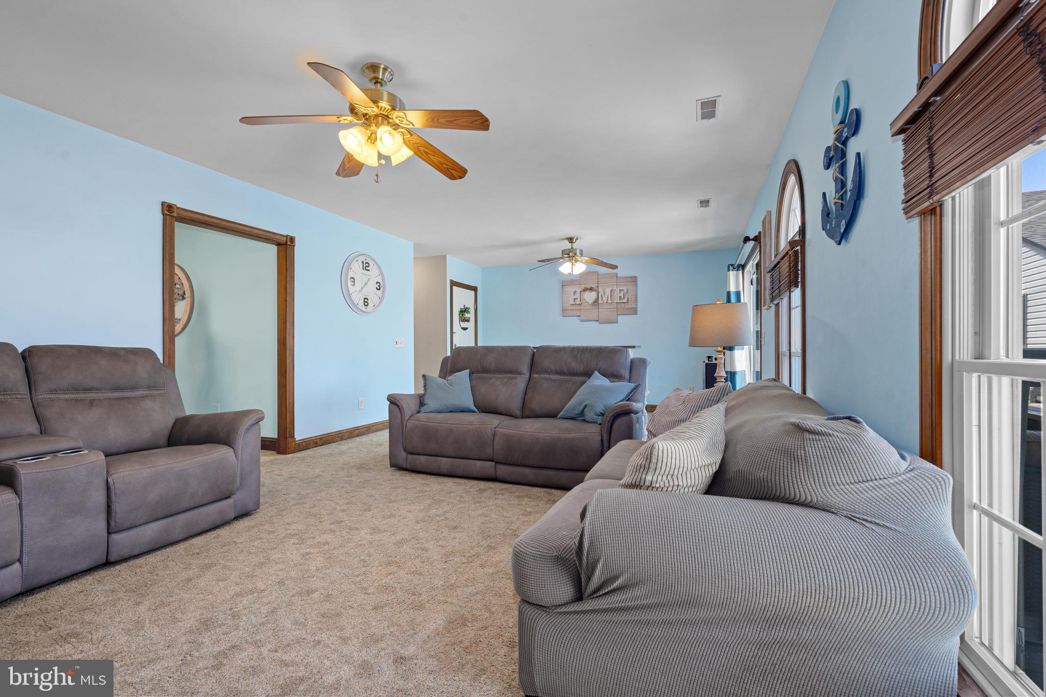 7808 Deboy Avenue Baltimore, MD 21222 - Photo 13 of 36 a living room with furniture a ceiling fan and a window