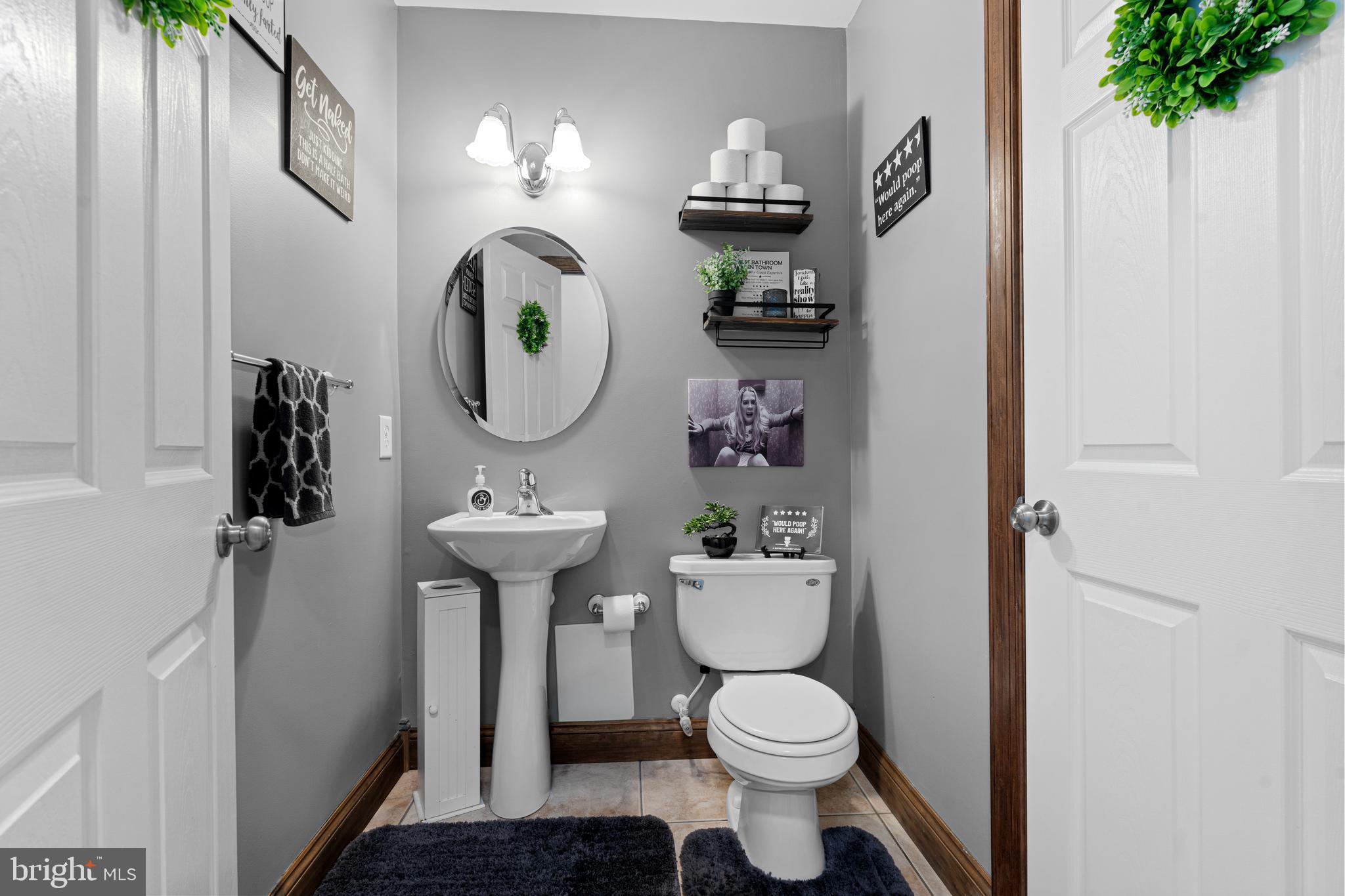 7808 Deboy Avenue Baltimore, MD 21222 - Photo 14 of 36 a bathroom with a toilet a sink and a mirror