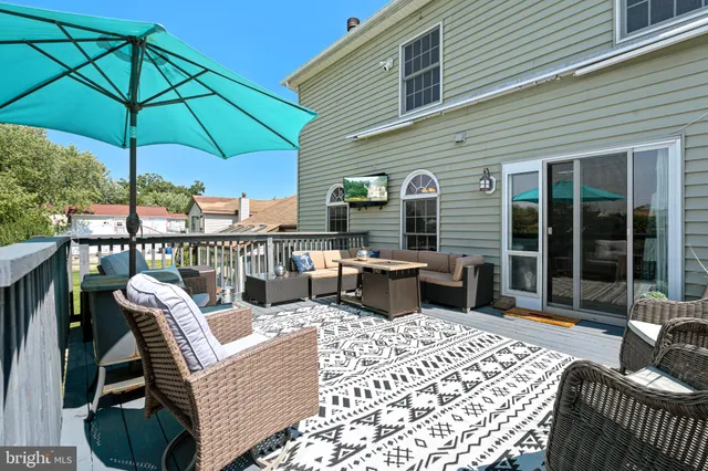 a view of a roof deck with furniture