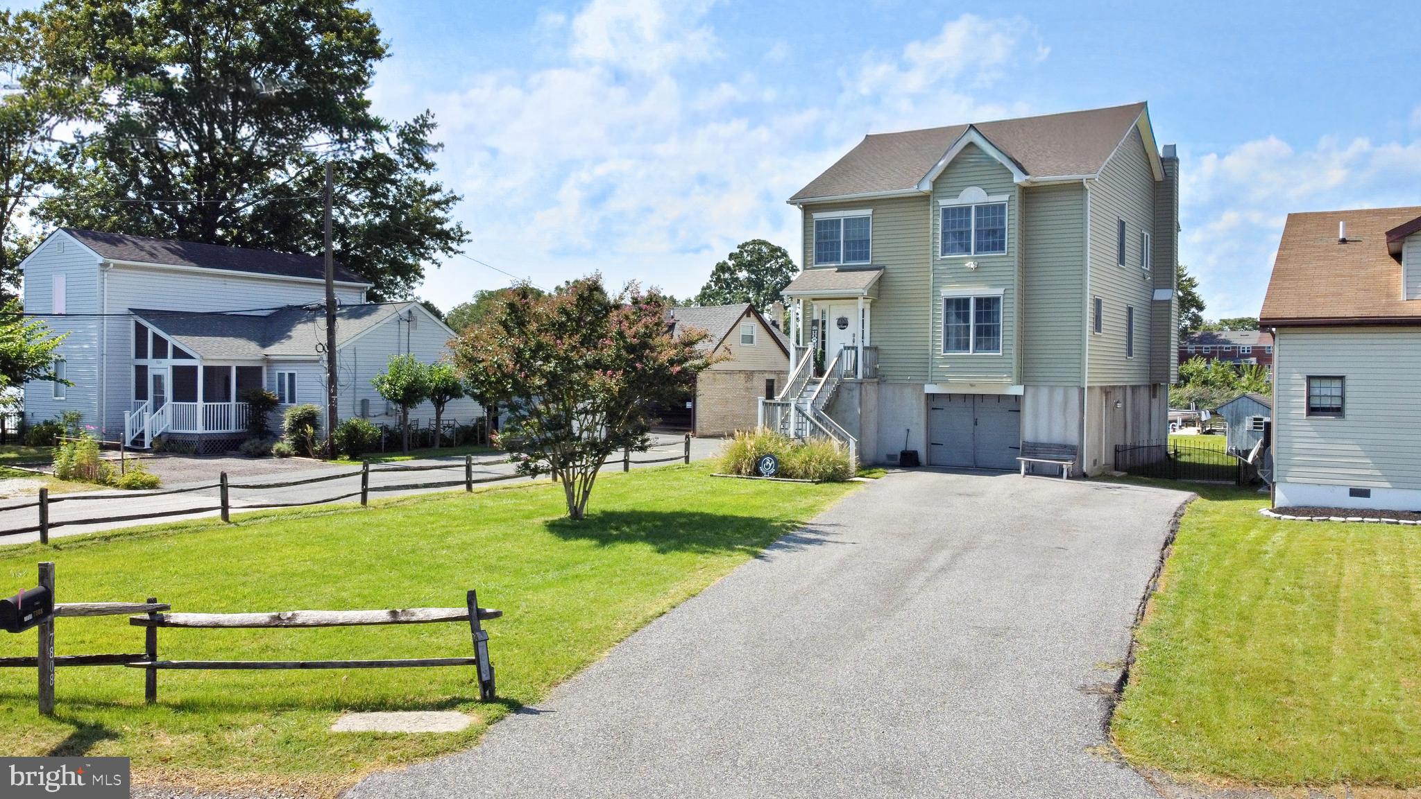 7808 Deboy Avenue Baltimore, MD 21222 - Photo 2 of 36 a front view of house with a garden and trees