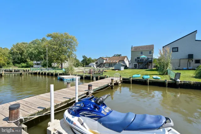 a view of a lake with couches chairs
