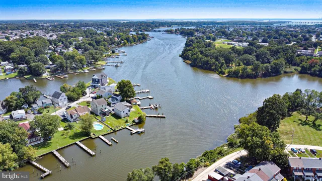 an aerial view of a house with a yard and lake view