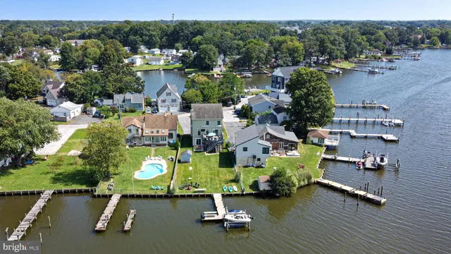 an aerial view of a houses with a yard