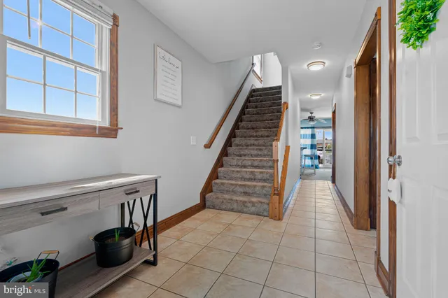 a view of entryway and hall with wooden floor