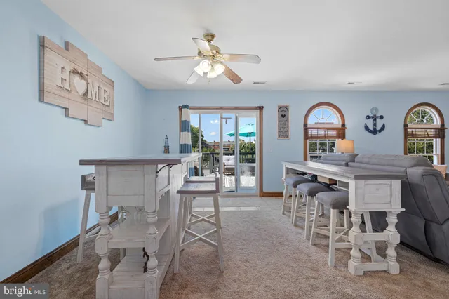 a view of a livingroom with furniture and a large window