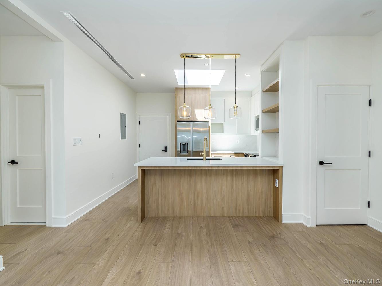 24 Lumber Road, Unit 2 Roslyn, NY 11576 - Photo 7 of 25 a kitchen with a sink and wooden floor