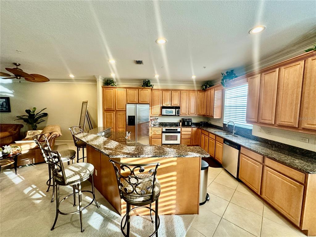135 Shoals Circle North Redington Beach, FL 33708 - Photo 17 of 80 a kitchen with stainless steel appliances kitchen island granite countertop a sink and cabinets