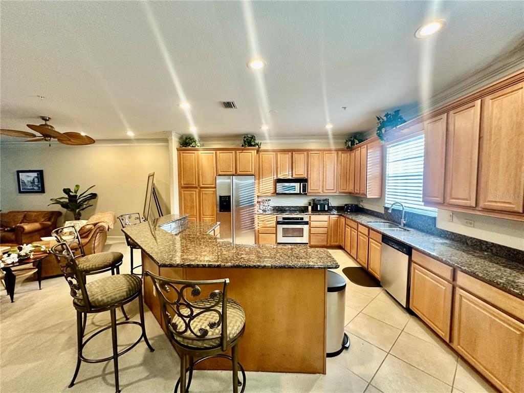 135 Shoals Circle North Redington Beach, FL 33708 - Photo 19 of 80 a kitchen with stainless steel appliances granite countertop a sink and cabinets