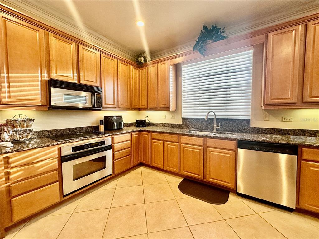 135 Shoals Circle North Redington Beach, FL 33708 - Photo 22 of 80 a kitchen with stainless steel appliances granite countertop a stove sink and cabinets