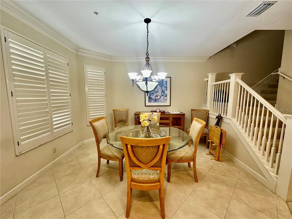 135 Shoals Circle North Redington Beach, FL 33708 - Photo 25 of 80 a dining room with furniture a chandelier and a window