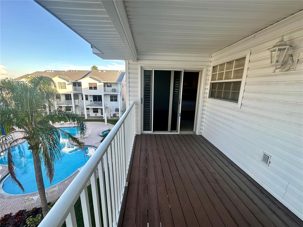 135 Shoals Circle North Redington Beach, FL 33708 - Photo 28 of 80 a view of a balcony with wooden floor and stairs