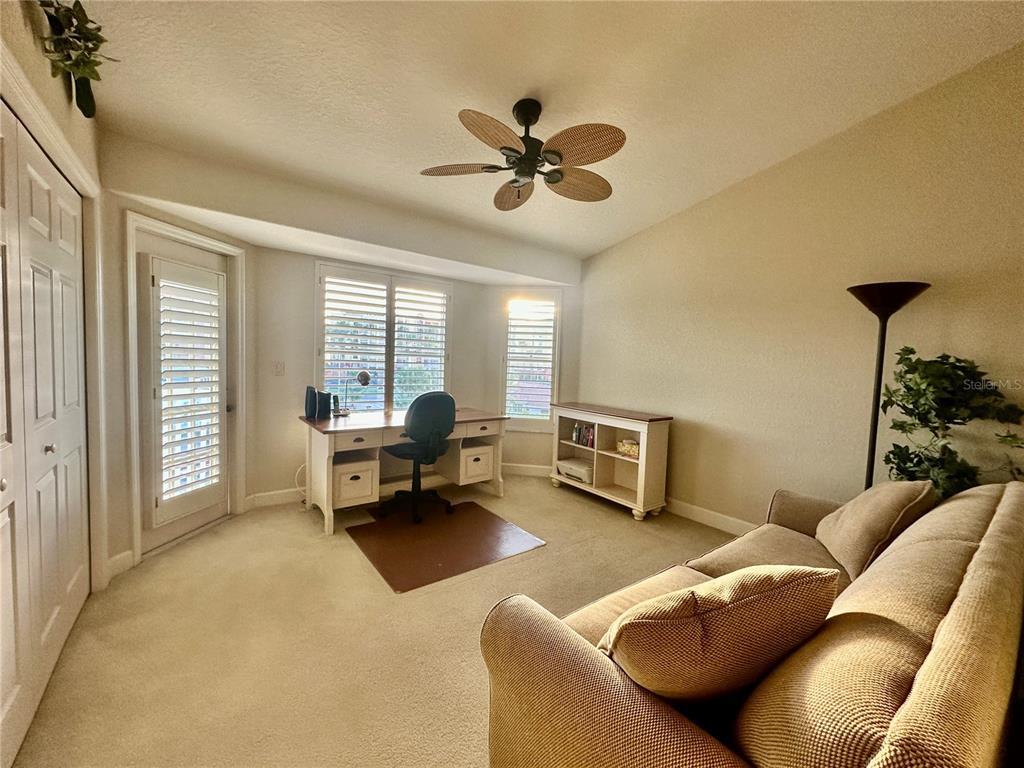 135 Shoals Circle North Redington Beach, FL 33708 - Photo 55 of 80 a living room with furniture and a large window