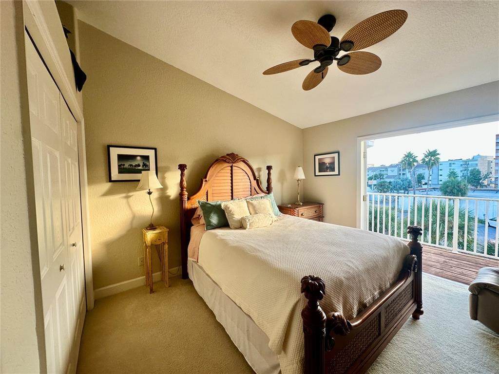 135 Shoals Circle North Redington Beach, FL 33708 - Photo 57 of 80 a bedroom with a bed and a chandelier