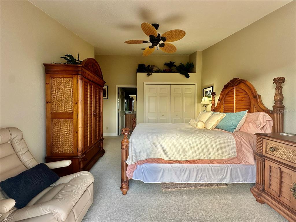 135 Shoals Circle North Redington Beach, FL 33708 - Photo 59 of 80 a bedroom with a bed and a chandelier