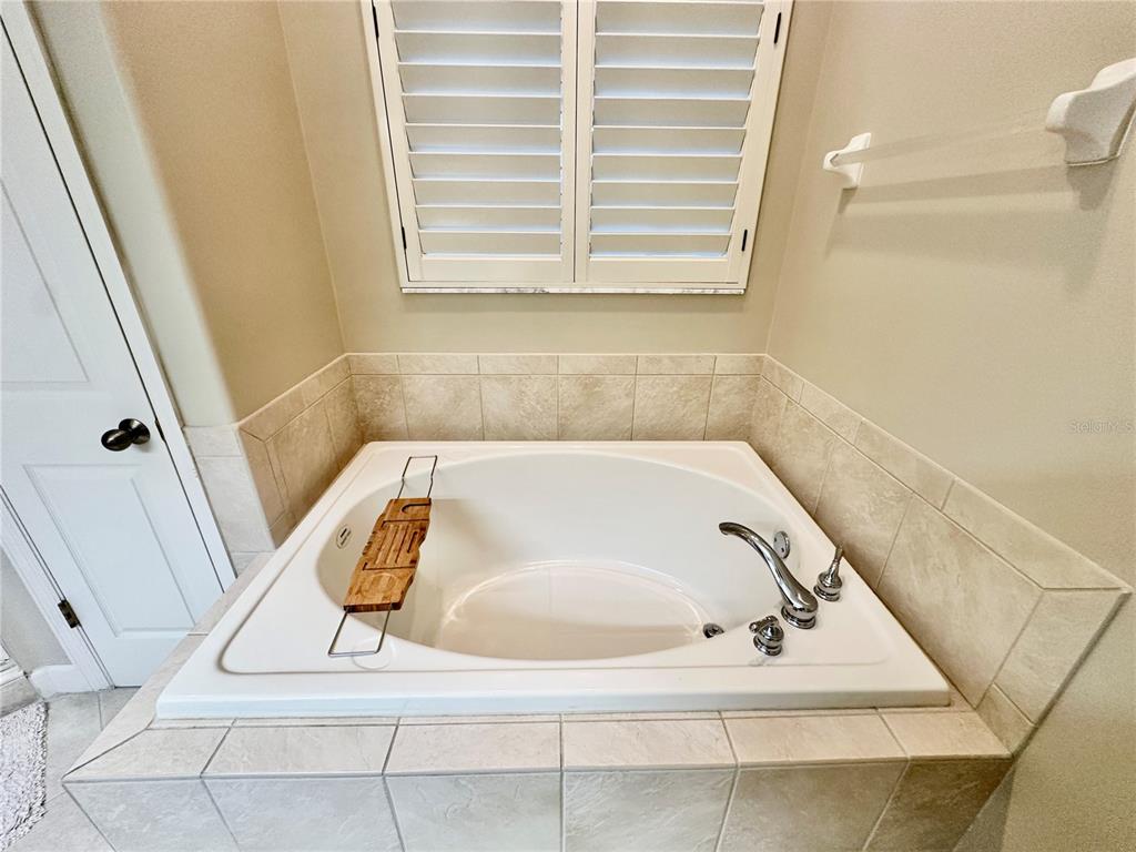 135 Shoals Circle North Redington Beach, FL 33708 - Photo 67 of 80 a bath tub sitting in a bathroom next to a sink