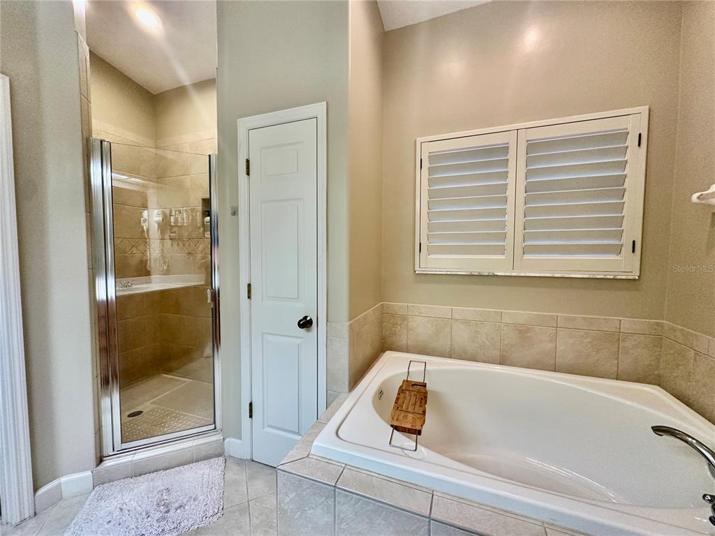 135 Shoals Circle North Redington Beach, FL 33708 - Photo 68 of 80 a bathroom with a tub a window and a shower